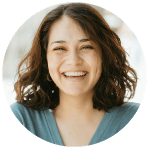Luca-testimonial young woman with blue v neck top wavy hair smiling